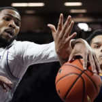 
              Kansas State forward David N'Guessan, left and Kansas City guard Tyler Andrews, right, chase a loose ball during the first half of an NCAA college basketball game Thursday, Nov. 17, 2022, in Manhattan, Kan. (AP Photo/Charlie Riedel)
            