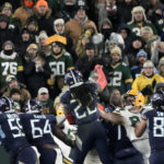 
              Tennessee Titans running back Derrick Henry (22) throws a touchdown pass that was caught by tight end Austin Hooper (81), not shown, during the second half of an NFL football game against the Green Bay Packers Thursday, Nov. 17, 2022, in Green Bay, Wis. (AP Photo/Morry Gash)
            