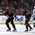 
              Ottawa Senators defenseman Travis Hamonic (23) celebrates his goal with left wing Tim Stutzle (18) as they skate back to the bench during the first period of an NHL hockey game against the Vancouver Canucks, Tuesday, Nov. 8, 2022 in Ottawa, Ontario. (Justin Tang/The Canadian Press via AP)
            