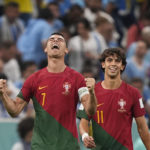 
              Portugal's Cristiano Ronaldo, left, celebrates , in front of his teammate Joao Felix the opening goal of his team against Uruguay during the World Cup group H soccer match between Portugal and Uruguay, at the Lusail Stadium in Lusail, Qatar, Monday, Nov. 28, 2022. (AP Photo/Martin Meissner)
            
