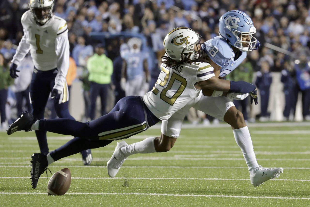 Georgia Tech defensive back LaMiles Brooks (20) breaks up a pass intended for North Carolina wide r...