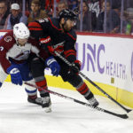 
              Carolina Hurricanes' Jordan Martinook (48) battles for the puck with Colorado Avalanche's Devon Toews (7) during the second period of an NHL hockey game in Raleigh, N.C., Thursday, Nov. 17, 2022. (AP Photo/Karl B DeBlaker)
            