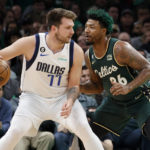 
              Dallas Mavericks guard Luka Doncic (77) drives against Boston Celtics guard Marcus Smart (36) during the first half of an NBA basketball game, Wednesday, Nov. 23, 2022, in Boston. (AP Photo/Mary Schwalm)
            