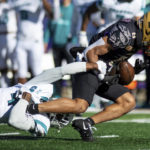 
              James Madison wide receiver Kris Thornton (8) tries to hang onto the ball as he gets tackled by Coastal Carolina safety Tobias Fletcher (4) during the first half of an NCAA college football game in Harrisonburg, Va., Saturday, Nov. 26, 2022. (Daniel Lin/Daily News-Record via AP)
            