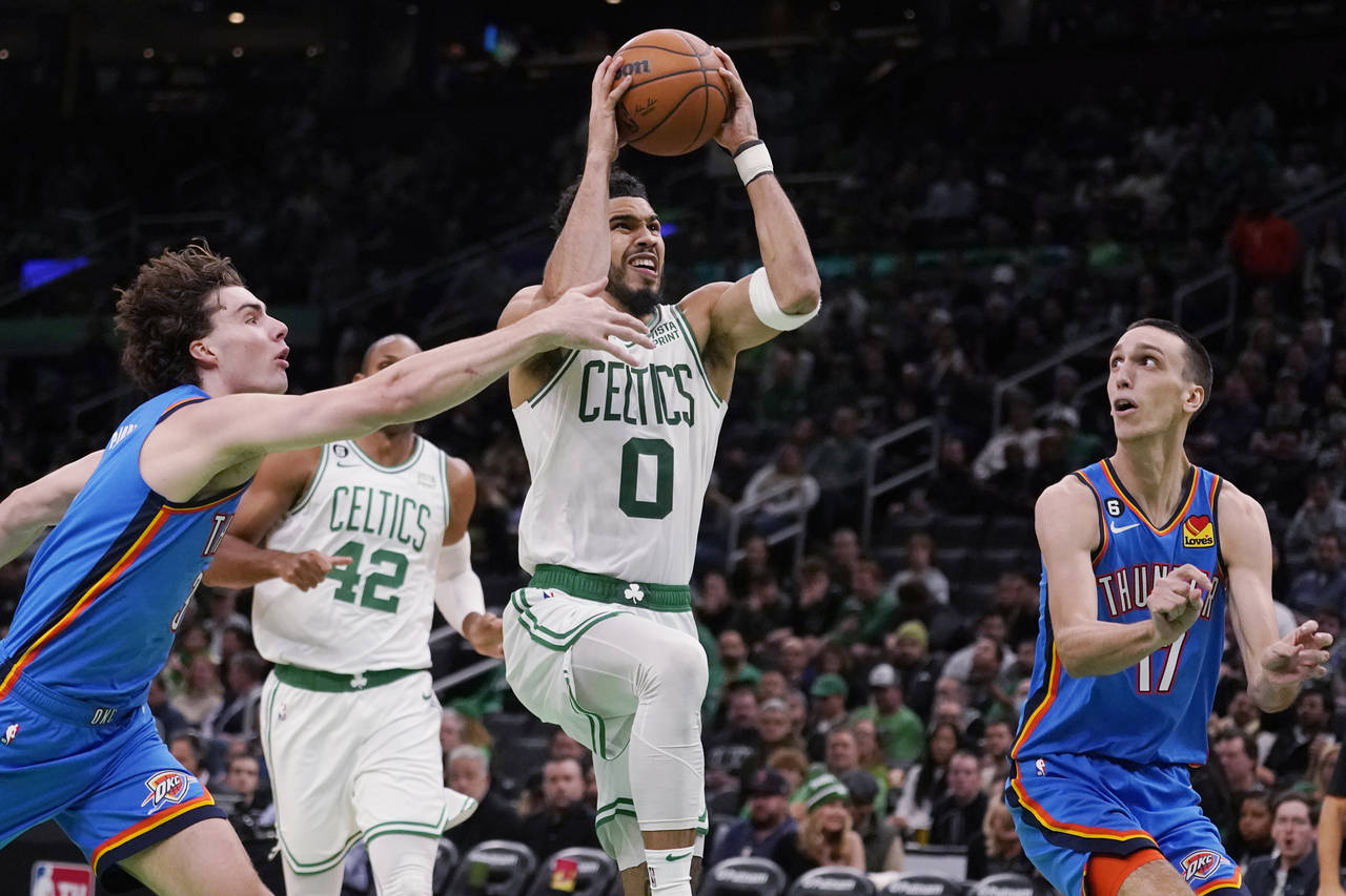Boston Celtics forward Jayson Tatum (0) drives to the basket against Oklahoma City Thunder guard Jo...