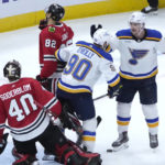
              St. Louis Blues' Ryan O'Reilly (90) begins to celebrate his goal with Noel Acciari as Chicago Blackhawks goaltender Arvid Soderblom watches during the second period of an NHL hockey game Wednesday, Nov. 16, 2022, in Chicago. (AP Photo/Charles Rex Arbogast)
            