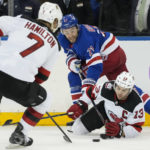 
              New Jersey Devils center Nico Hischier (13) and New York Rangers center Barclay Goodrow (21) battle for the puck in the second period of an NHL hockey game, Monday, Nov. 28, 2022, in New York. (AP Photo/John Minchillo)
            
