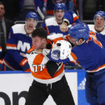 
              Philadelphia Flyers defenseman Tony DeAngelo, left, and New York Islanders right wing Oliver Wahlstrom fight in front of the Islanders bench in the third period of an NHL hockey game Saturday, Nov. 26, 2022, in Elmont, N.Y. (AP Photo/John Munson)
            