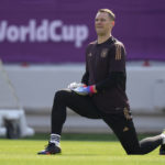 
              Germany's goalkeeper Manuel Neuer stretches during a training session at the Al-Shamal stadium on the eve of the group E World Cup soccer match between Germany and Japan, in Al-Ruwais, Qatar, Tuesday, Nov. 22, 2022. Germany will play the first match against Japan on Wednesday, Nov. 23. (AP Photo/Matthias Schrader)
            
