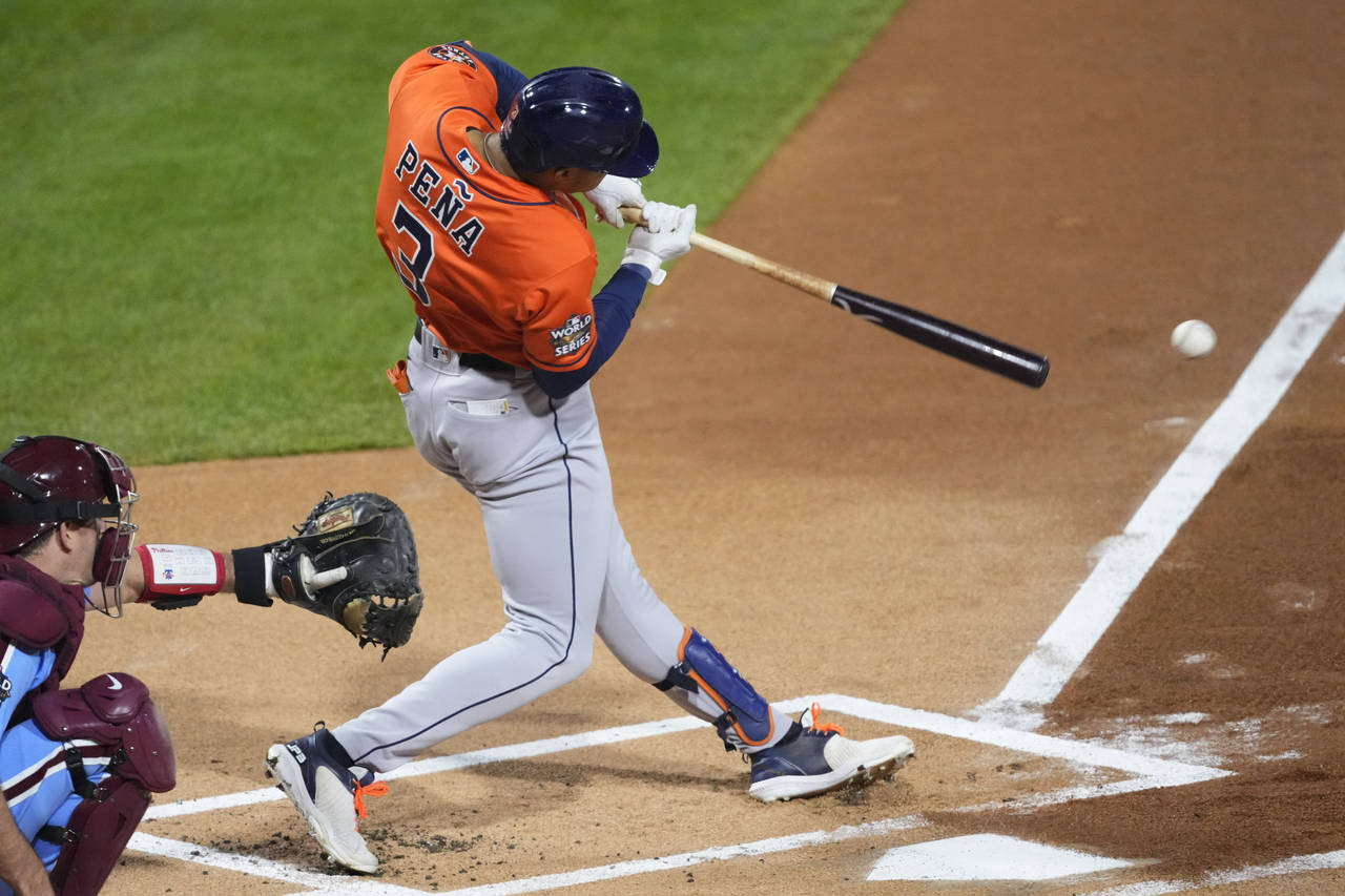 Houston Astros' Jeremy Pena hits an hits an RBI single during the first inning in Game 5 of basebal...
