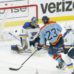 
              Florida Panthers center Carter Verhaeghe (23) scores a goal against St. Louis Blues goaltender Thomas Greiss (1) during the first period of an NHL hockey game, Saturday, Nov. 26, 2022, in Sunrise, Fla. (AP Photo/Marta Lavandier)
            