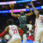
              Minnesota Timberwolves' Karl-Anthony Towns, center, passes the ball while Philadelphia 76ers' Joel Embiid, right, defends the basket during the first half of an NBA basketball game, Saturday, Nov. 19, 2022, in Philadelphia. (AP Photo/Chris Szagola)
            