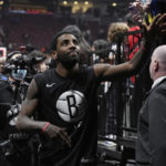 
              Brooklyn Nets guard Kyrie Irving greets fans after the team's 112-98 win over the Toronto Raptors in an NBA basketball game Wednesday, Nov. 23, 2022, in Toronto. (Chris Young/The Canadian Press via AP)
            