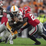 
              Tennessee running back Jaylen Wright (20) is stopped by Georgia defensive back Tykee Smith (23) during the second half of an NCAA college football game Saturday, Nov. 5, 2022 in Athens, Ga. (AP Photo/John Bazemore)
            