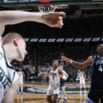 
              Michigan State's Joey Hauser (10) passes the ball over Villanova's Eric Dixon (43) as he is running out of bounds during the second half of an NCAA college basketball game, Friday, Nov. 18, 2022, in East Lansing, Mich. (AP Photo/Al Goldis)
            