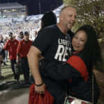 
              North Carolina State head coach Dave Doeren, left, celebrates with a fan after his team defeated North Carolina in overtime in an NCAA college football game Friday, Nov. 25, 2022, in Chapel Hill, N.C. (AP Photo/Chris Seward)
            
