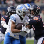 
              Detroit Lions wide receiver Amon-Ra St. Brown (14) runs after a catch against the Chicago Bears during the first half of an NFL football game in Chicago, Sunday, Nov. 13, 2022. (AP Photo/Charles Rex Arbogast)
            
