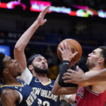 
              Chicago Bulls guard Zach LaVine goes to the basket against New Orleans Pelicans guard Trey Murphy III and forward Larry Nance Jr., center, in the first half of an NBA basketball game in New Orleans, Wednesday, Nov. 16, 2022. (AP Photo/Gerald Herbert)
            