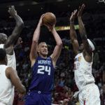 
              Charlotte Hornets center Mason Plumlee (24) drives to the basket as Miami Heat forward Jimmy Butler (22) defends during the first half of an NBA basketball game Thursday, Nov. 10, 2022, in Miami. (AP Photo/Marta Lavandier)
            