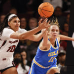 
              South Carolina center Kamilla Cardoso (10), left, battles UCLA forward Emily Bessoir (11) for a rebound during the first half of an NCAA college basketball game in Columbia, S.C., Tuesday, Nov. 29, 2022. (AP Photo/Nell Redmond)
            