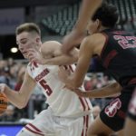 
              Wisconsin's Tyler Wahl drives past Stanford's Brandon Angel during the first half of an NCAA college basketball game Friday, Nov. 11, 2022, in Milwaukee. The game is being played at American Family Field, home of the Milwaukee Brewers. (AP Photo/Morry Gash)
            