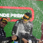 
              Second place finisher Mercedes driver Lewis Hamilton, of Britain, left, sprays champagne on race winner and teammate George Russell, of Britain, at the podium in the Brazilian Formula One Grand Prix at the Interlagos race track in Sao Paulo, Brazil, Sunday, Nov.13, 2022. (AP Photo/Andre Penner)
            