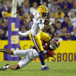 
              LSU quarterback Jayden Daniels (5) is tackled by Alabama defensive back Brian Branch, bottom, during the first half of an NCAA college football game in Baton Rouge, La., Saturday, Nov. 5, 2022. (AP Photo/Tyler Kaufman)
            