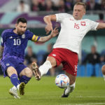 
              Poland's Kamil Glik, center, tries to block a shot from Argentina's Lionel Messi during the World Cup group C soccer match between Poland and Argentina at the Stadium 974 in Doha, Qatar, Wednesday, Nov. 30, 2022. (AP Photo/Ariel Schalit)
            