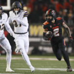 
              Oregon State wide receiver Anthony Gould (2) runs past California safety Daniel Scott (32) and wide receiver Kenden Robinson Jr. for a touchdown off of a punt return during the first half of an NCAA college football game on Saturday, Nov 12, 2022, in Corvallis, Ore. (AP Photo/Amanda Loman)
            