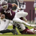 
              Texas A&M wide receiver Moose Muhammad III (7) is tackled by Massachusetts defensive back Tyler Rudolph (2) after a first down catch and run during the second half of an NCAA college football game, Saturday, Nov. 19, 2022, in College Station, Texas. (AP Photo/Sam Craft)
            