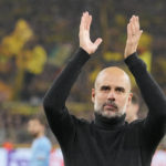 
              Manchester City's head coach Pep Guardiola applauds fans at the end of the Champions League Group G soccer match between Borussia Dortmund and Manchester City in Dortmund, Germany, Tuesday, Oct. 25, 2022. (AP Photo/Martin Meissner)
            