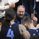 
              Memphis Grizzlies coach Taylor Jenkins talks to players during a timeout in the second half of the team's NBA basketball game against the San Antonio Spurs, Wednesday, Nov. 9, 2022, in San Antonio. The Grizzlies won 124-122 in overtime. (AP Photo/Darren Abate)
            