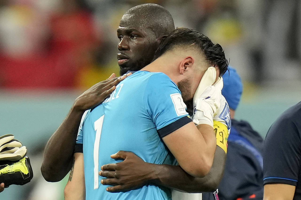Ecuador's goalkeeper Hernan Galindez is comforted by Senegal's Kalidou Koulibaly after losing the W...