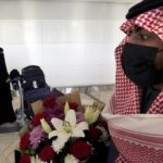 
              FILE - Saudi Bandar Al-Qahtani holds flowers as he waits for the arrival of his relatives on the first Qatar Airways plane in three years to land at King Khalid Airport in Riyadh, Saudi Arabia, Jan. 11, 2021. Qatar will be on the world stage like it never has before as the small, energy-rich nations hosts the 2022 FIFA World Cup beginning this November. (AP Photo/Amr Nabil, File)
            