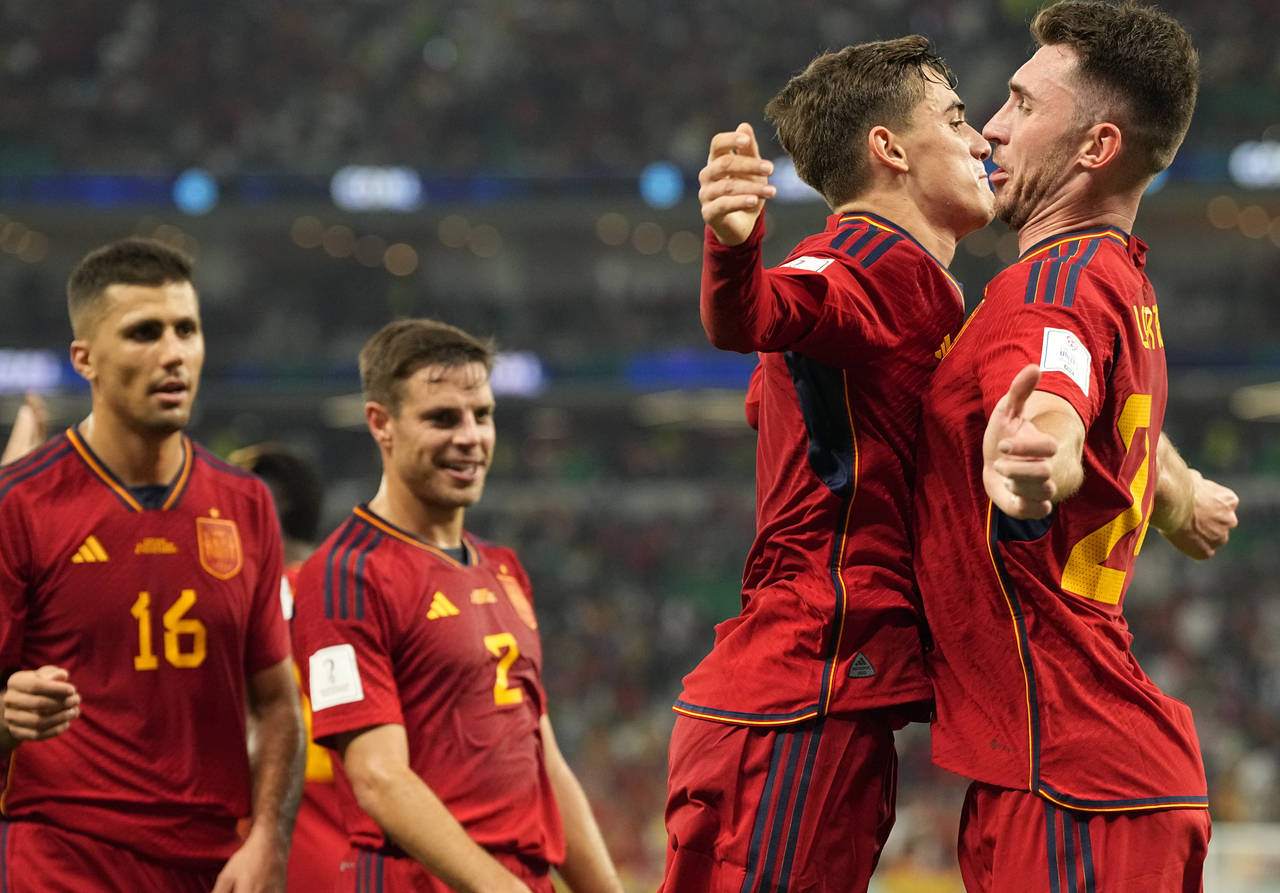 Spain's Gavi, second right, celebrates with Aymeric Laporte after scoring his side's fifth goal dur...