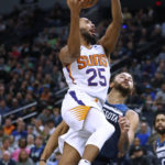 
              Phoenix Suns forward Mikal Bridges (25) goes to the basket over Minnesota Timberwolves forward Kyle Anderson during the first quarter of an NBA basketball game Wednesday, Nov. 9, 2022, in Minneapolis. (AP Photo/Bruce Kluckhohn)
            