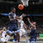 
              Villanova's Brandon Slater, left, Michigan State's Malik Hall, center, and Villanova's Eric Dixon, right, vie for a rebound during the second half of an NCAA college basketball game Friday, Nov. 18, 2022, in East Lansing, Mich. (AP Photo/Al Goldis)
            