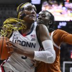 
              Connecticut's Aaliyah Edwards  drives to the basket as Texas' Amina Muhammad, right, defends during the first half of an NCAA college basketball game, Monday, Nov. 14, 2022, in Storrs, Conn. (AP Photo/Jessica Hill)
            