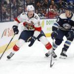 
              Florida Panthers forward Anton Lundell, left, controls the puck in front of Columbus Blue Jackets defenseman Gavin Bayreuther during the first period an NHL hockey game in Columbus, Ohio, Sunday, Nov. 20, 2022. (AP Photo/Paul Vernon)
            
