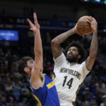
              New Orleans Pelicans forward Brandon Ingram (14) shoots against Golden State Warriors guard Ty Jerome in the first half of an NBA basketball game in New Orleans, Monday, Nov. 21, 2022. (AP Photo/Gerald Herbert)
            