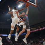
              Houston Christian guard Pierce Bazil (2) is blocked by Texas forward Timmy Allen (0) as he tries to score during the first half of an NCAA college basketball game, Thursday, Nov. 10, 2022, in Austin, Texas. (AP Photo/Eric Gay)
            