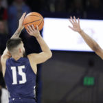 
              North Florida guard Jose Placer, left, shoots while defended by Gonzaga guard Rasir Bolton during the first half of an NCAA college basketball game, Monday, Nov. 7, 2022, in Spokane, Wash. (AP Photo/Young Kwak)
            