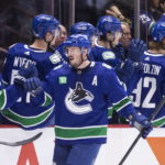 
              Vancouver Canucks' J.T. Miller is congratulated for his goal against the Anaheim Ducks during the second period of an NHL hockey game Thursday, Nov. 3, 2022, in Vancouver, British Columbia. (Ben Nelms/The Canadian Press via AP)
            