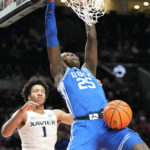 
              Duke forward Mark Mitchell (25) dunks against Xavier guard Desmond Claude (1) during the second half of an NCAA college basketball game in the Phil Knight Legacy tournament Friday, Nov. 25, 2022, in Portland, Ore. (AP Photo/Rick Bowmer)
            