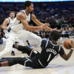 
              Los Angeles Clippers guard Reggie Jackson (1) looks to pass from the floor against Dallas Mavericks guard Spencer Dinwiddie (26) during the first quarter of an NBA basketball game in Dallas, Tuesday, Nov. 15, 2022. (AP Photo/LM Otero)
            