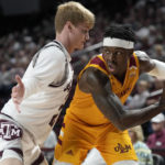 
              Louisiana-Monroe guard Devon Hancock (2) looks to pass the ball as Texas A&M guard Hayden Hefner (2) defends during the first half of an NCAA college basketball game Monday, Nov. 7, 2022, in College Station, Texas. (AP Photo/Sam Craft)
            