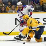 
              New York Rangers center Vincent Trocheck (16) passes the puck past Nashville Predators' Nino Niederreiter (22) in the first period of an NHL hockey game Saturday, Nov. 12, 2022, in Nashville, Tenn. (AP Photo/Mark Humphrey)
            