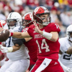 
              Indiana quarterback Jack Tuttle (14) drops back to pass during the first half of an NCAA college football game against Penn State, Saturday, Nov. 5, 2022, in Bloomington, Ind. (AP Photo/Doug McSchooler)
            