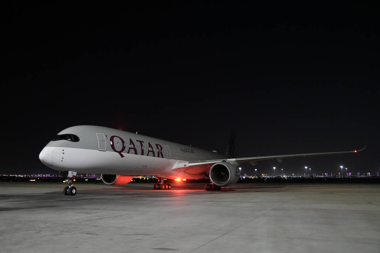 A Qatar Airways aircraft lands with members of the United States national soccer team at Hamad Inte...