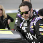 
              FILE - Jimmie Johnson climbs into his car before the NASCAR Daytona 500 auto race at Daytona International Speedway in Daytona Beach, Fla., Feb. 16, 2020. Seven-time NASCAR champion Jimmie Johnson is returning to NASCAR two years after his retirement from the stock car series. Johnson bought a stake in GMS Petty Racing, a Cup team fronted by seven-time champion Richard Petty. Johnson will also run up to five races in 2023 beginning with the season-opening Daytona 500. (AP Photo/John Raoux, File)
            